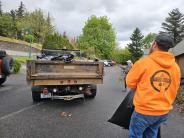 Public works team loading trash into truck