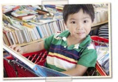 Happy child reading at the library