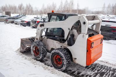 Bobcat Plowing Parking Lot